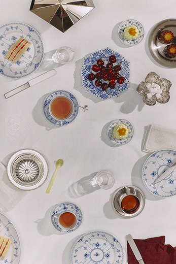 An elegant table set with Blue Fluted Half Lace and Blue Fluted Full Lace